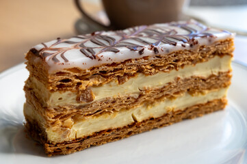 Portion of french mille-feuille cake, vanilla or custard slice, Napoleon puff pastry layered with pastry cream in bakery