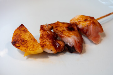 Typical snacks of Basque Country, pinchos or pinxtos skewers with small pieces of bread, fish, sea food, sweet green pepper served in bar in San-Sebastian or Bilbao, Spain