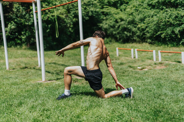 Fit and strong male sports person working out in a park, demonstrating strength, agility, and...
