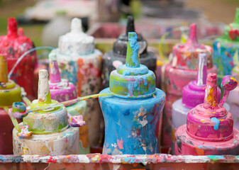 Colorful paint bottles in an old basket