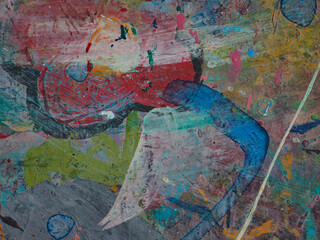 Paint smeared on the table has colorful patterns.
