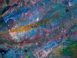 Paint smeared on the table has colorful patterns.
