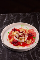 Savor the delicious dessert that combines fresh fruits and an exquisite sauce topping