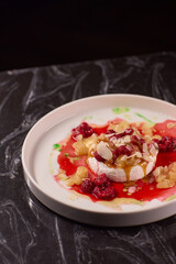 Savor the delicious dessert that combines fresh fruits and an exquisite sauce topping