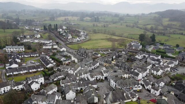 Aerial drone footage of Hawkshead Village and St Michael and All Angels Church.Cumbria UK.
