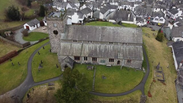 Aerial drone footage of Hawkshead Village and St Michael and All Angels Church.Cumbria UK.