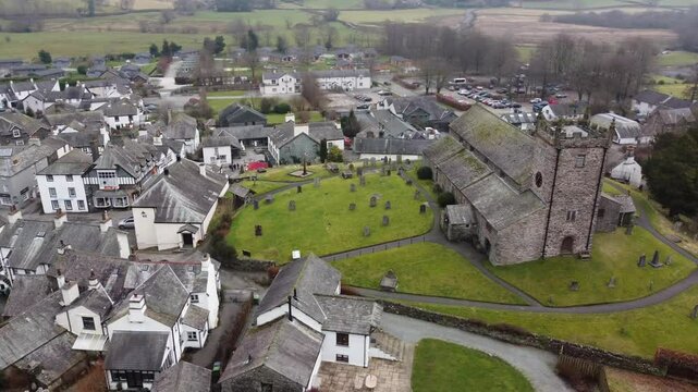 Aerial drone footage of Hawkshead Village and St Michael and All Angels Church.Cumbria UK.