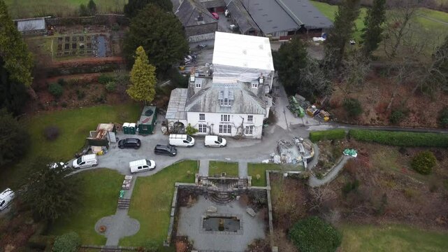 Aerial drone footage of Hawkshead Village and St Michael and All Angels Church.Cumbria UK.