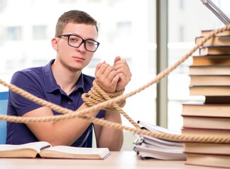 Young student forced to study tied