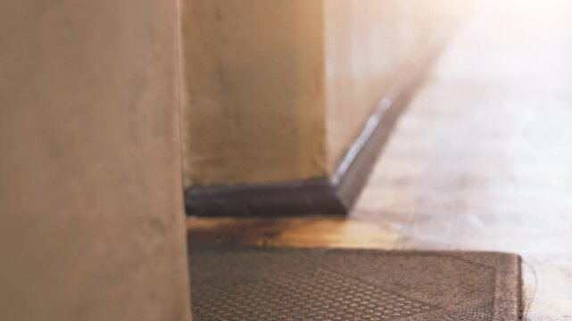 Hands Collecting Multiple Packages: Low-Angle View of Man Retrieving Stack of Boxes from Doormat - Static Shot of Home Delivery in Urban Apartment Setting