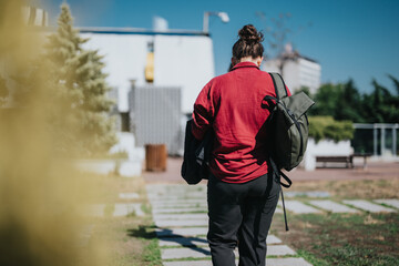 Businessperson walking in a sunny city park with backpack and suitcase, enjoying a peaceful break outside.