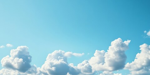 Sunny day with clear blue skies and cottony clouds, capturing the beauty of nature and the warmth of a summer day