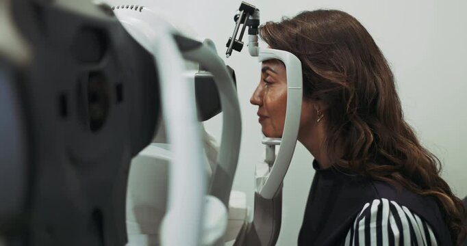 Woman, optometry and eye exam with machine in hospital, vision assessment and depth perception of test. Patient, slit lamp and diagnostic procedure for pupil reaction, medical care and glaucoma check