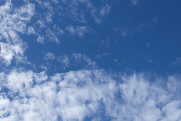 Blue sky background with clouds, Sun rays in the cloudy sky. Nature background.