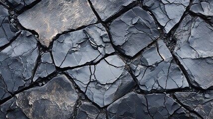 Fototapeta premium Detailed image of rough, cracked asphalt with visible stones