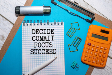 Decide Commit Focus Succeed symbol. Concept words Decide Commit Focus Succeed on wooden blocks.