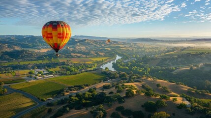 Fototapeta premium Show a traveler enjoying a hot air balloon ride, soaring above a beautiful landscape dotted with vineyards and quaint villages.
