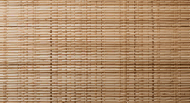 A close-up view of a bamboo mat or screen, showcasing the natural texture and pattern of the bamboo sticks arranged horizontally and vertically. Japanese traditional tatami texture.