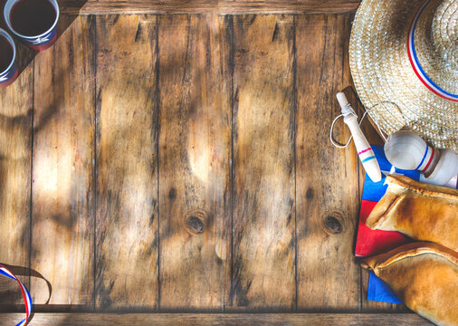 Chilean independence day concept. fiestas patrias. Tipical baked empanadas, wine or chicha, fat and play emboque. Decoration for 18 september party day, wooden background, top view