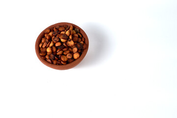 small clay vessel full of toasted filbert (scientific name: Gevuina avellana)