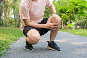 Man with knee pain, he puts his hand on his knee, pain point from osteoarthritis and...