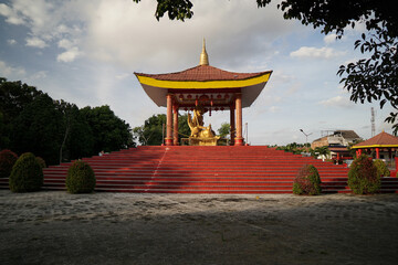 beautiful small monastery with a buddha statue in the center located near the monastery.