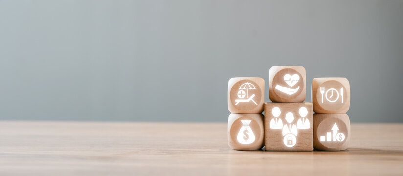 Wooden blocks with icons symbolizing various employee benefits such as health, financial perks, and wellness programs, illustrating modern workplace incentives.