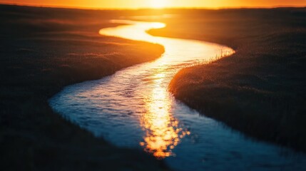 Sunset over a winding river with glowing reflections and copy space.