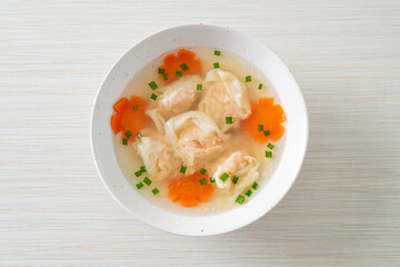 shrimp dumpling soup in white bowl