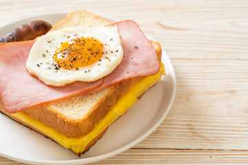 bread toasted cheese topped ham and fried egg with pork sausage