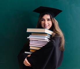 Female graduate student in front of green board