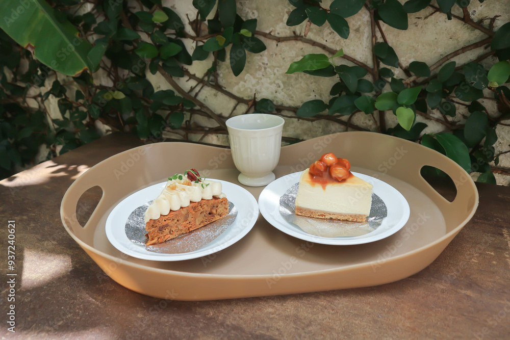 Wall mural carrot cake with cream and walnut topping ,caramel macadamia cheesecake and hot tea