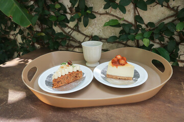 carrot cake with cream and walnut topping ,caramel macadamia cheesecake and hot tea