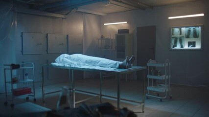 Covered body of a deceased woman on the table at the morgue