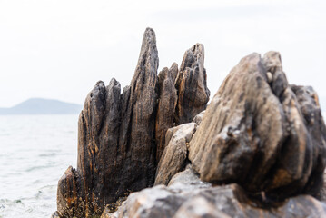 Timeworn rocks, sculpted by years of relentless waves, reveal the raw beauty of nature’s...