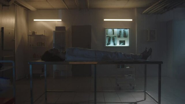 Side view of Covered body of a deceased woman on the table at the morgue
