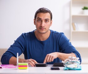 Young man in budget planning concept