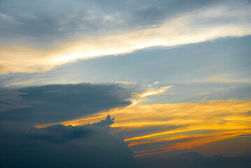 Golden and black clouds in the sky before the sun sets. n, beautiful colorful clouds