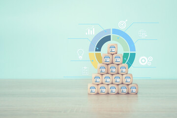 Cube wooden stack pyramid with franchise icon and arrow goal for investment planning growth...
