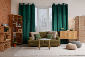 Stylish interior of living room with sofa near brick window