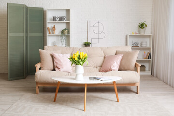Stylish interior of living room with beautiful sofa