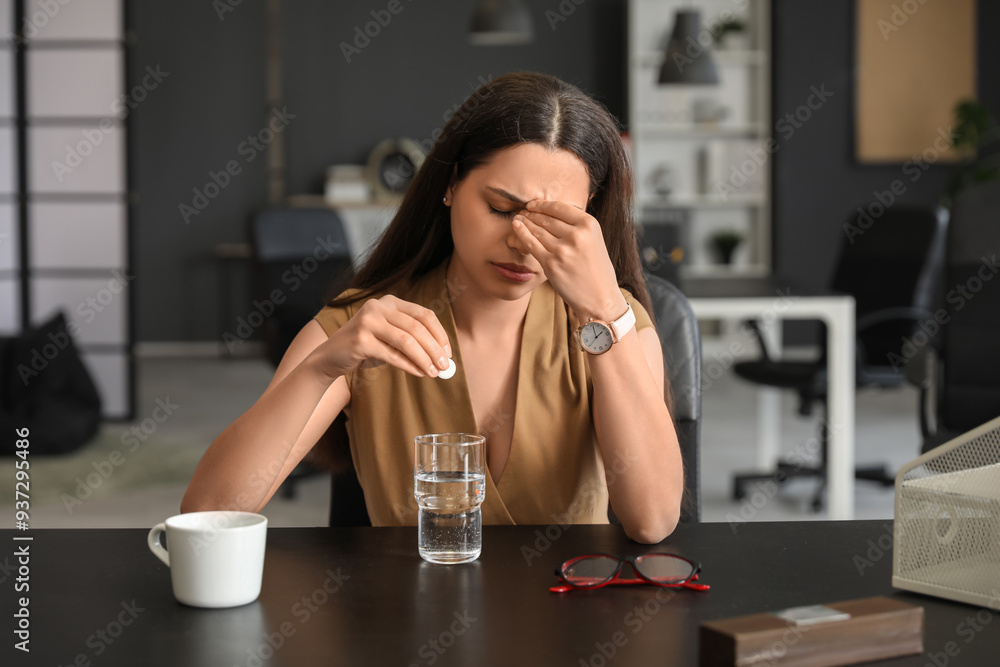 Poster young woman with glass of water and soluble tablet suffering from headache sitting in office