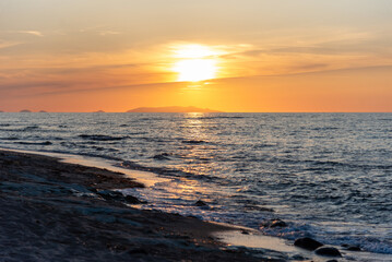 Beautiful scenic sunset over mediterranean sea, seen from the Valledoria beach, Sardinia, Italy. 
