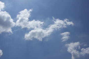A blue sky with puffy clouds.