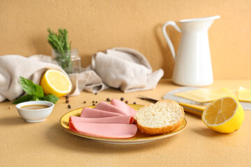 Plate with slices of tasty boiled sausage, bread and mustard sauce on beige background