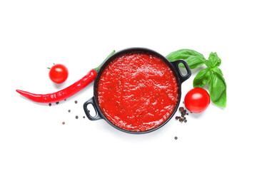 Frying pan of tomato sauce with basil, chili pepper and peppercorn on white background