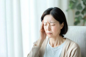 Portrait of an Elderly Woman Experiencing Headache or Stress at Home