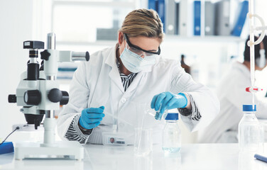 Woman, scientist and liquid with beaker in lab for microscope, chemical experiment or assessment...