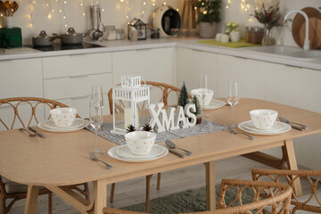 Table setting with Christmas decor in kitchen
