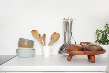 Cooking utensils with bread on counter in kitchen